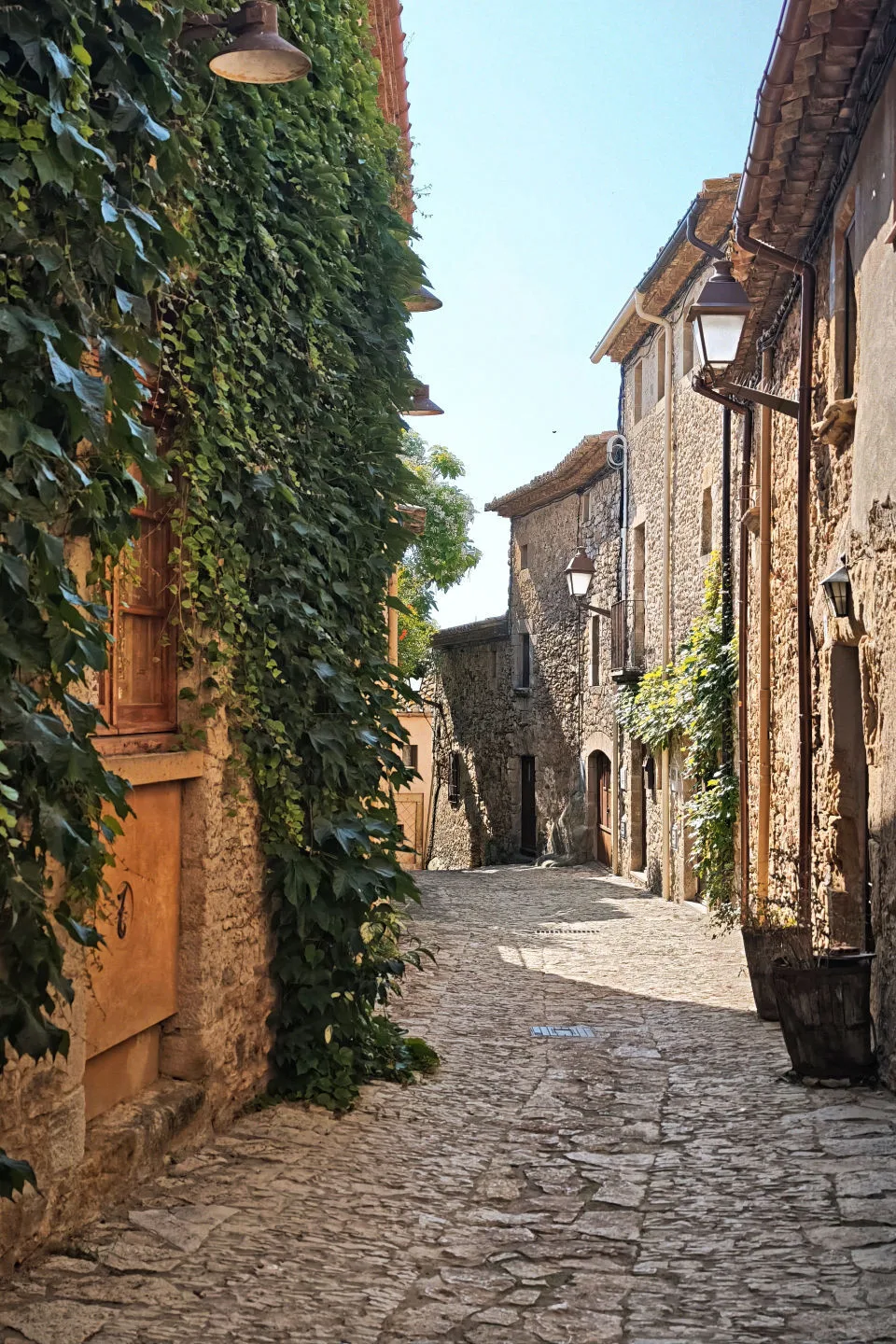 Stone houses covered in ivy and a beautiful medieval alley in Peratallada