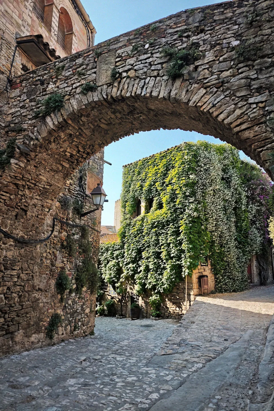 A medieval house covered in ivy in the town of Peratallada