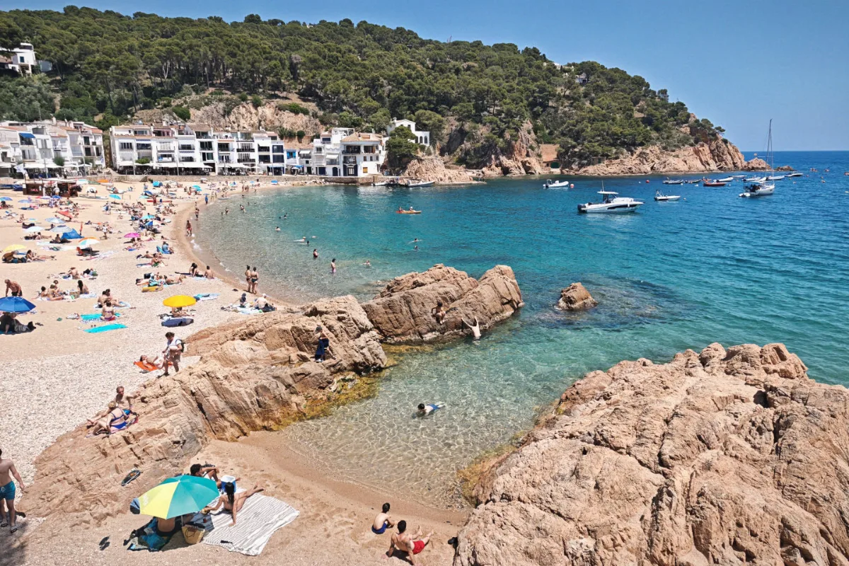 Tamariu beach in Costa Brava with the town in the background